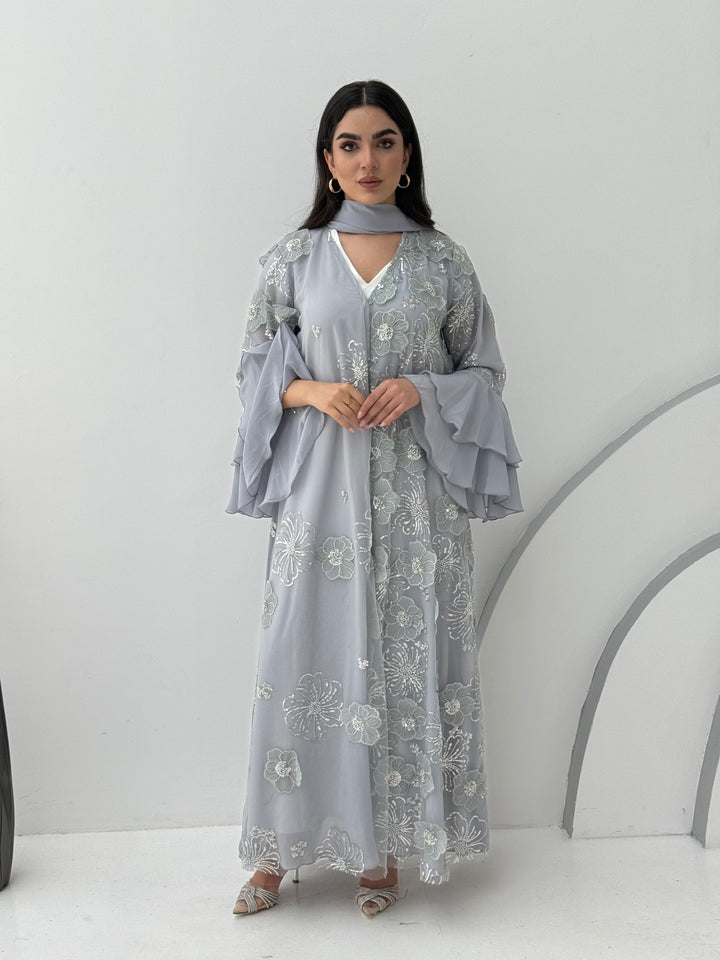 A luxurious light grey abaya with chiffon and texture of Black floral lace. This abaya is perfect for evening outings and occasions.
