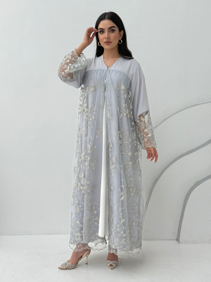 A luxurious and romantic light grey abaya with floral lace and Nida fabric, that is perfect for engagements, henna parties and weddings.