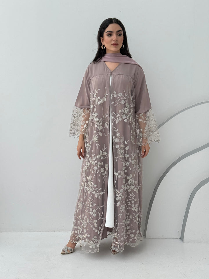 A luxurious and romantic mauve pink abaya with floral lace and Nida fabric, that is perfect for engagements, henna parties and weddings.