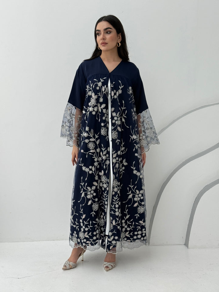 A luxurious and romantic navy blue abaya with floral lace and Nida fabric, that is perfect for engagements, henna parties and weddings.