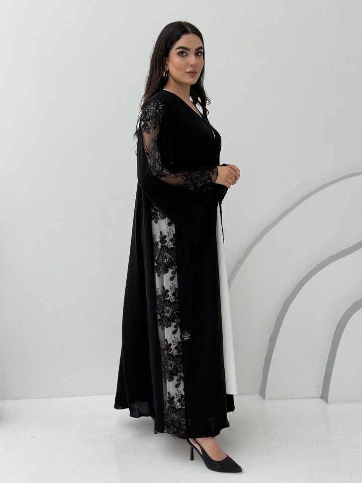 A black nida premium fabric abaya, that has floral lace (dantel) panel run vertically down the sides and sleeves.Perfect for Eid and special events.
