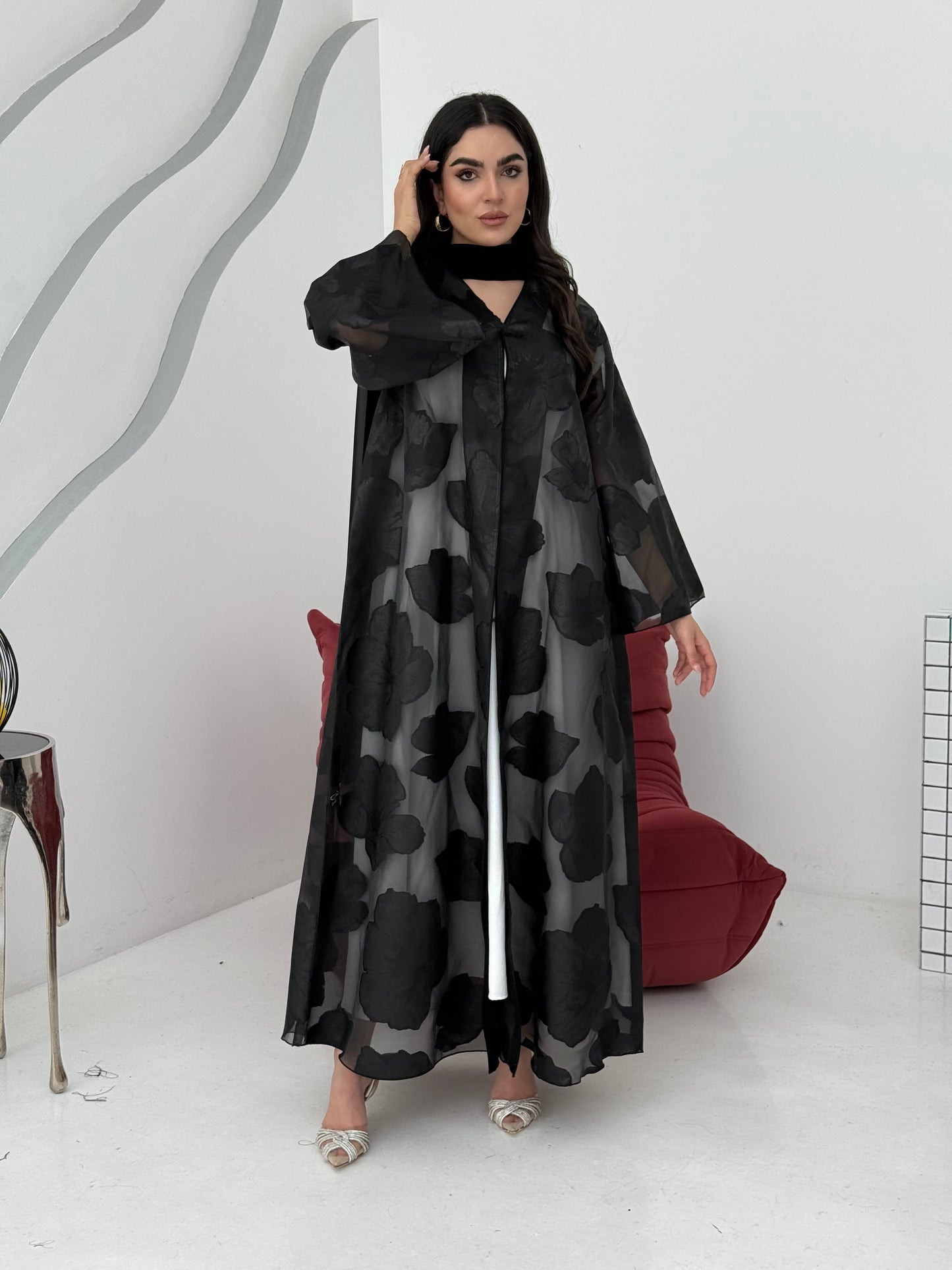 A black floral abaya crafted from organza and lace fabric. Perfect choice for events.