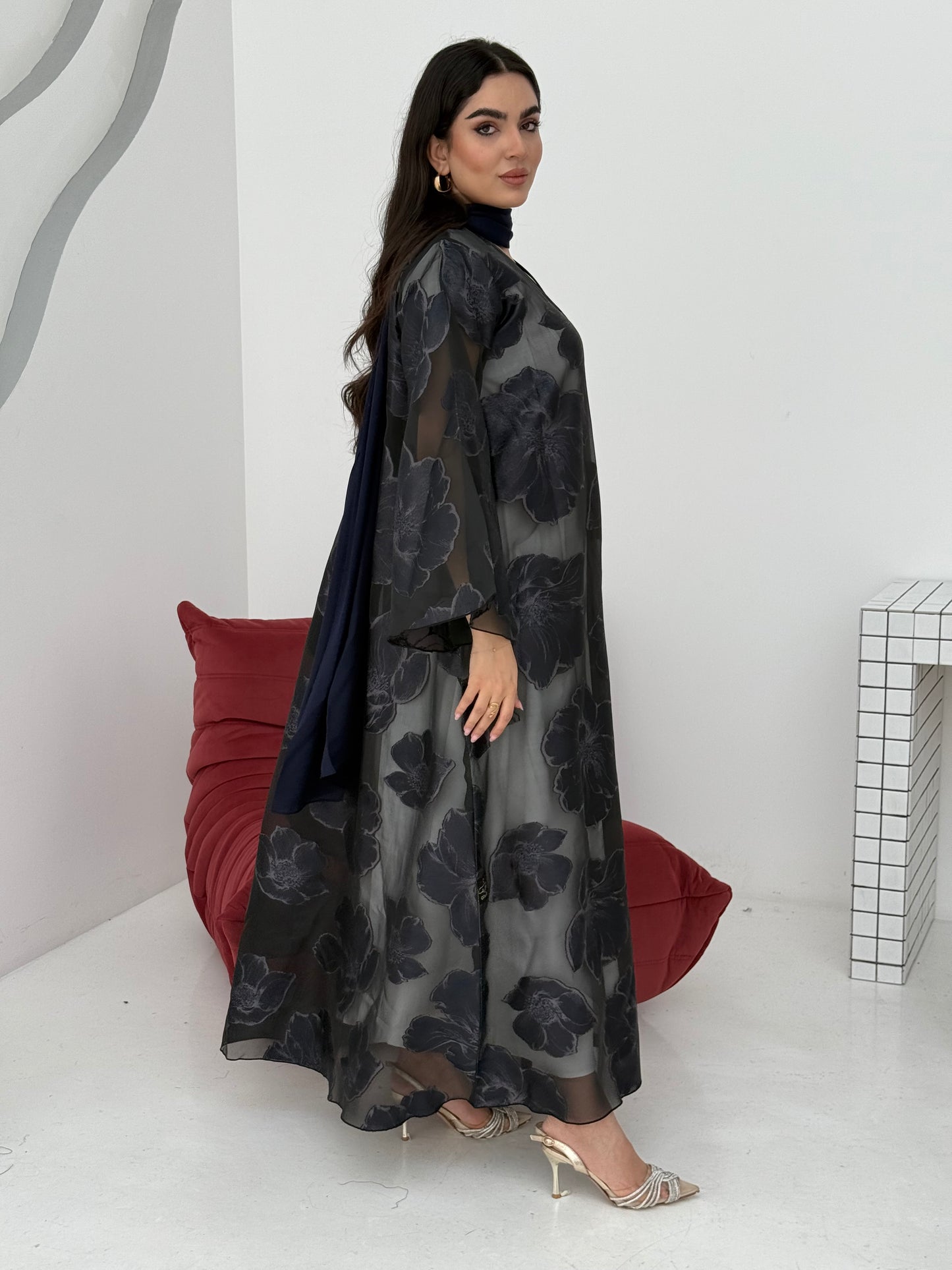 A navy blue floral abaya crafted from organza and lace fabric. Perfect choice for events.
