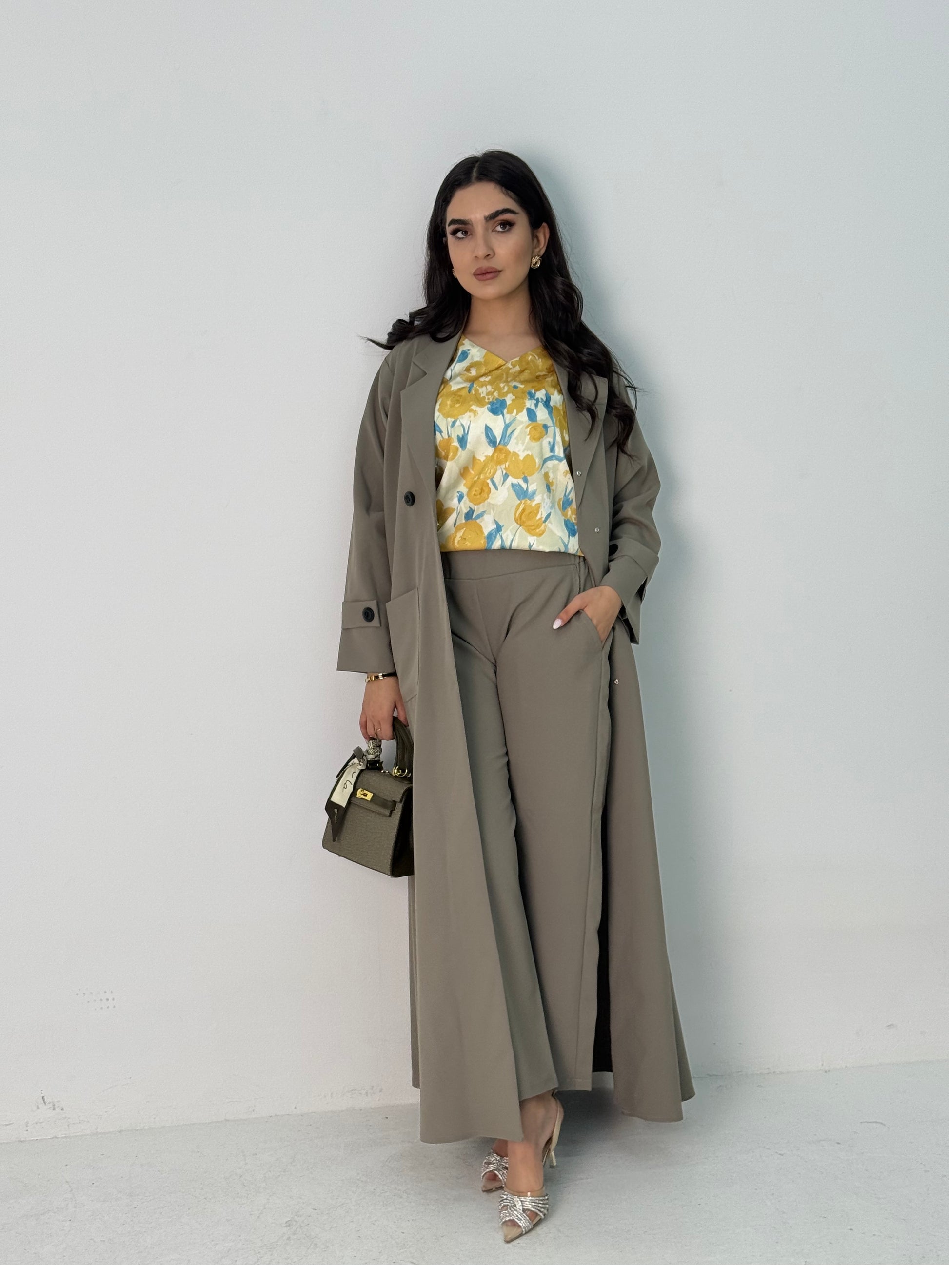 A sage green abaya set that includes a coat abaya, matching pants, printed top, and sheila. This set is perfect for formal events, office wear, and university.