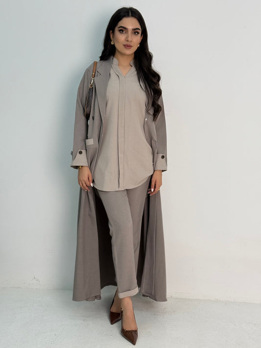 A set of beige abaya that includes matching trousers, coat abaya, inner top and sheila. This abaya set is perfect for travels and corporate events.