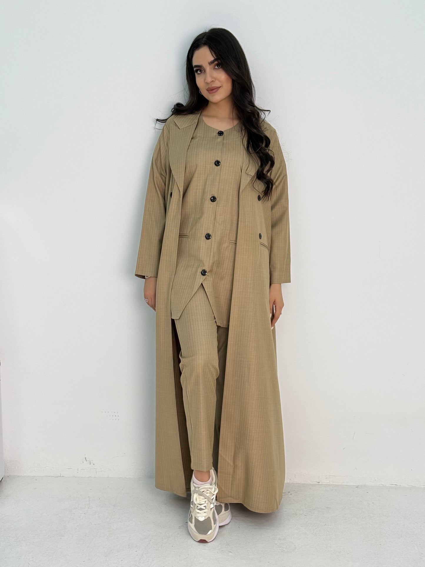 A beige pinstripe 4 piece abaya set that includes a coat abaya, matching trouser, waistcoat top and sheila. This abaya set is perfect for daytime formal events or office wear and travel.