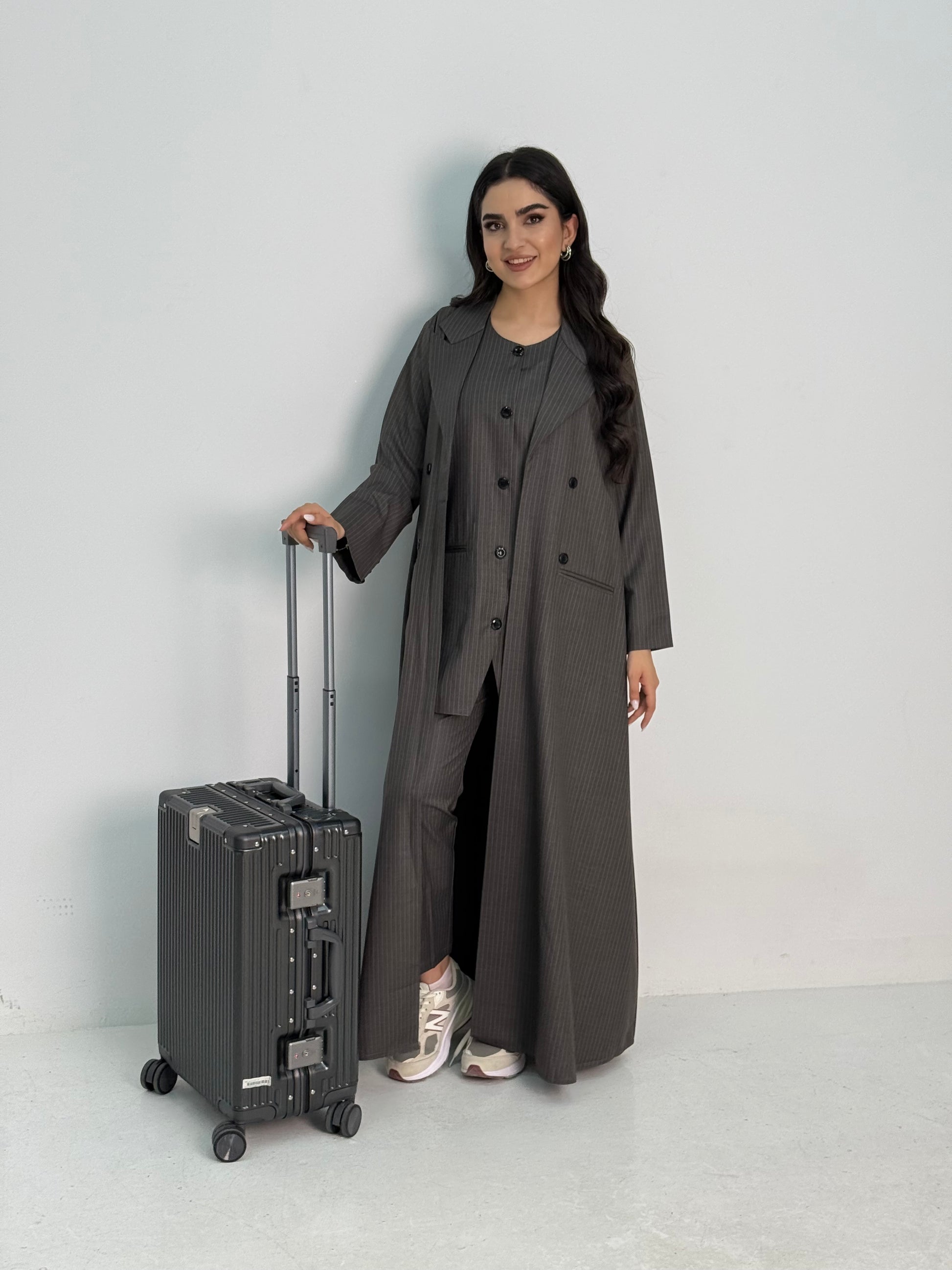 A dark grey pinstripe 4 piece abaya set that includes a coat abaya, matching trouser, waistcoat top and sheila. This abaya set is perfect for daytime formal events or office wear and travel.
