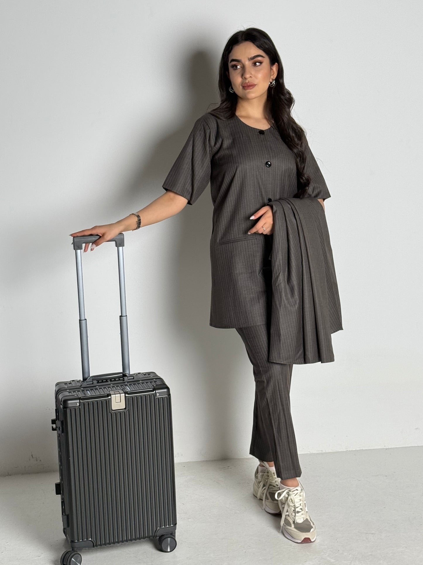 A dark grey pinstripe 4 piece abaya set that includes a coat abaya, matching trouser, waistcoat top and sheila. This abaya set is perfect for daytime formal events or office wear and travel.