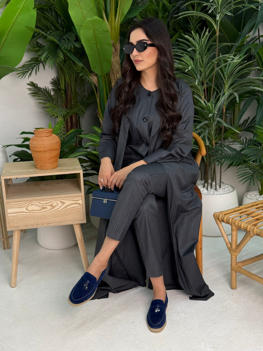 A dark navy pinstripe 4 piece abaya set that includes a coat abaya, matching trouser, waistcoat top and sheila. This abaya set is perfect for daytime formal events or office wear and travel.