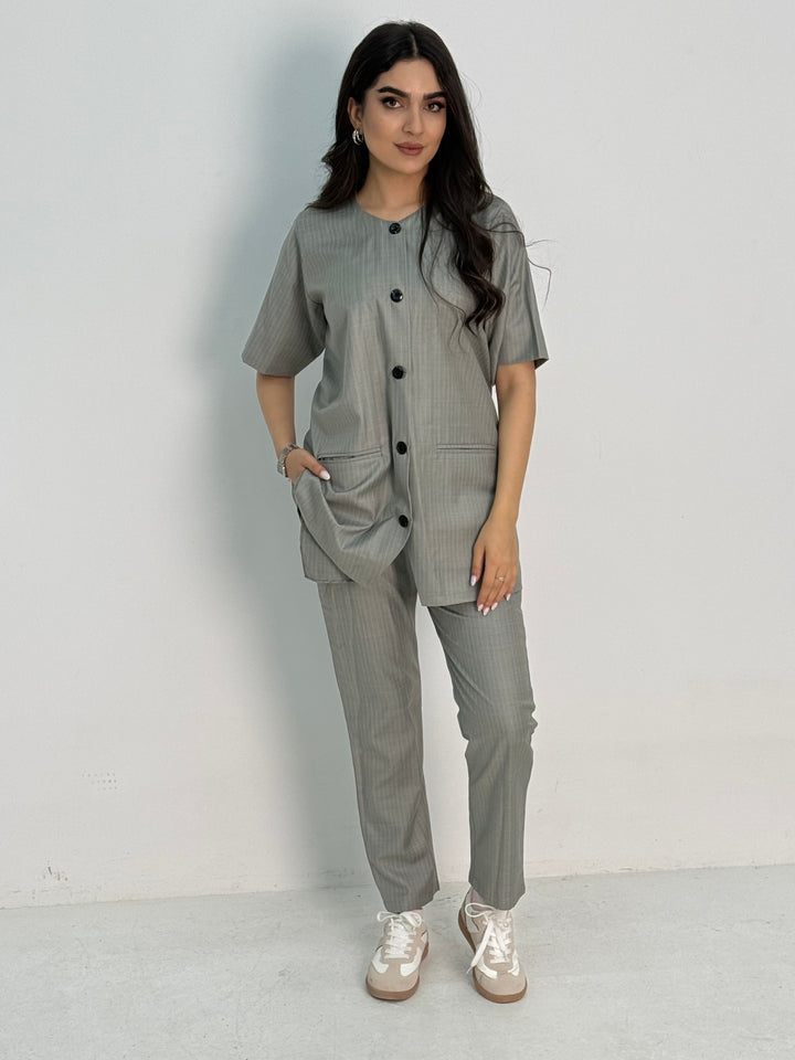A light grey pinstripe 4 piece abaya set that includes a coat abaya, matching trouser, waistcoat top and sheila. This abaya set is perfect for daytime formal events or office wear and travel.