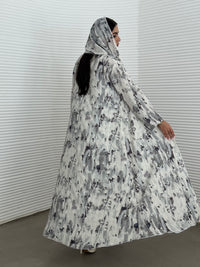 A grey printed satin abaya, an elegant abaya perfect for summer, daytime events, and artistic gatherings.