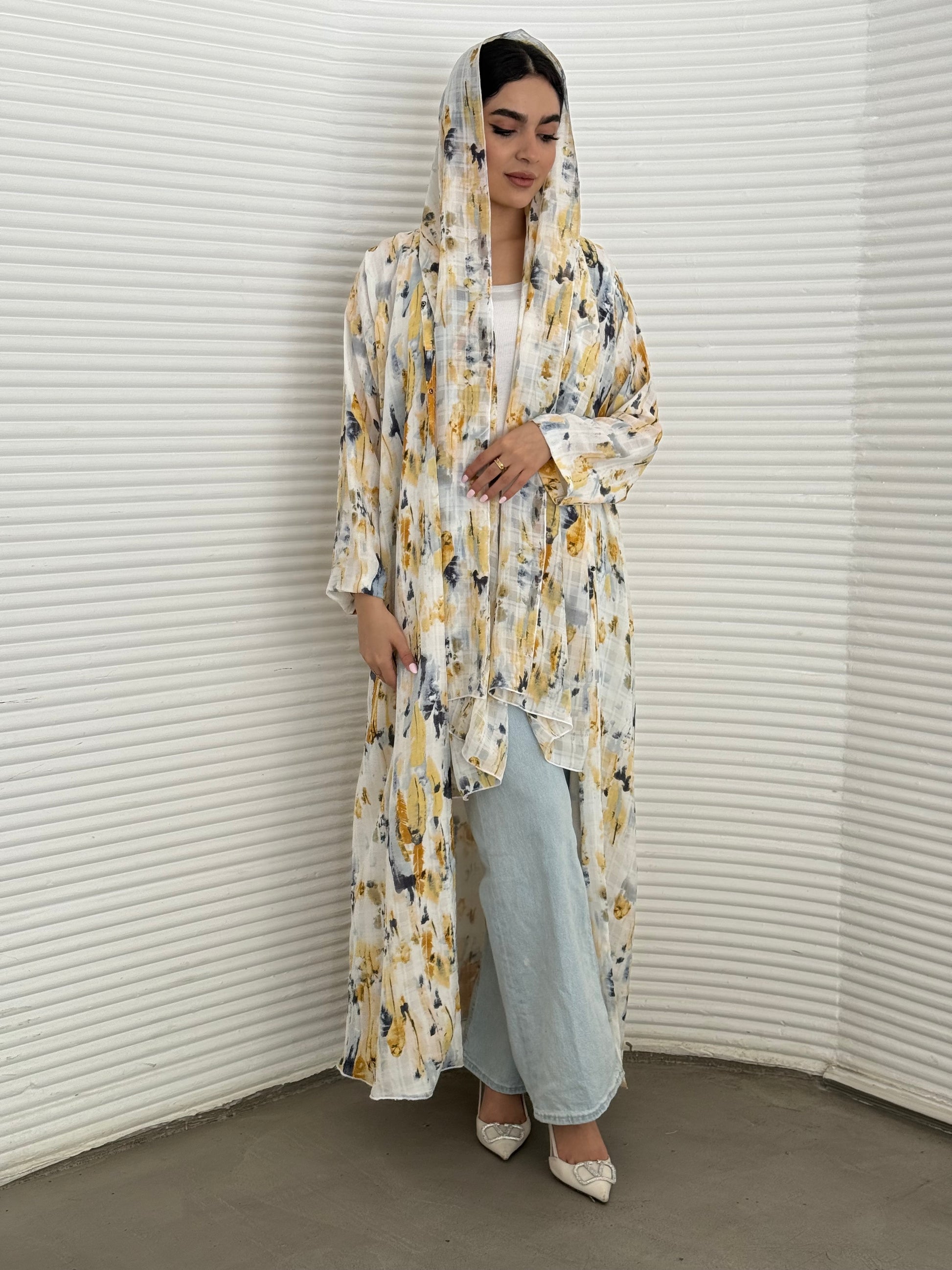A yellow printed satin abaya, an elegant abaya that is perfect for summer, daytime events, artistic gatherings.