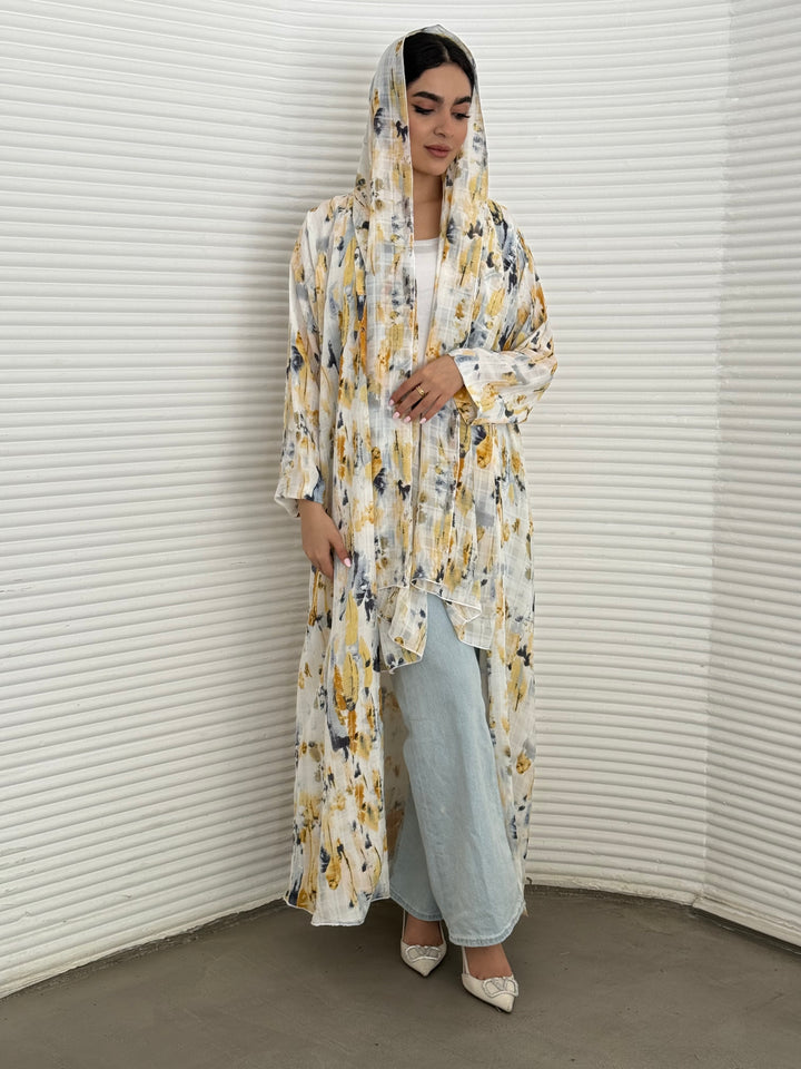 A yellow printed satin abaya, an elegant abaya that is perfect for summer, daytime events, artistic gatherings.