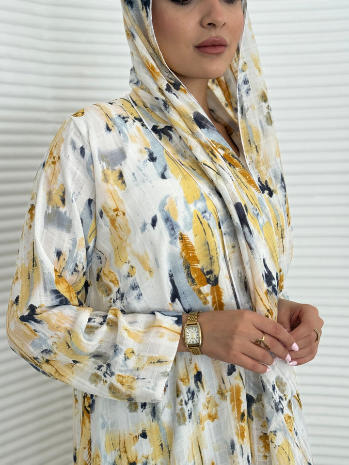 A yellow printed satin abaya, an elegant abaya that is perfect for summer, daytime events, artistic gatherings.