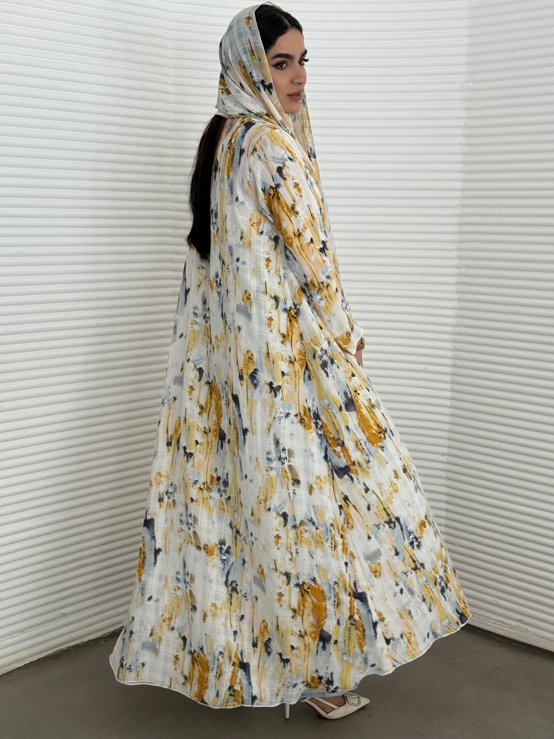 A yellow printed satin abaya, an elegant abaya that is perfect for summer, daytime events, artistic gatherings.