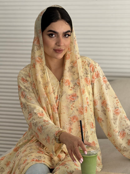 A soft yellow floral chiffon abaya, an elegant abaya that is perfect for summer, daytime events, artistic gatherings.