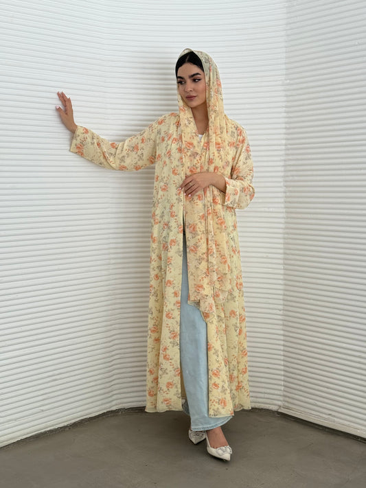 A soft yellow floral chiffon abaya, an elegant abaya that is perfect for summer, daytime events, artistic gatherings.