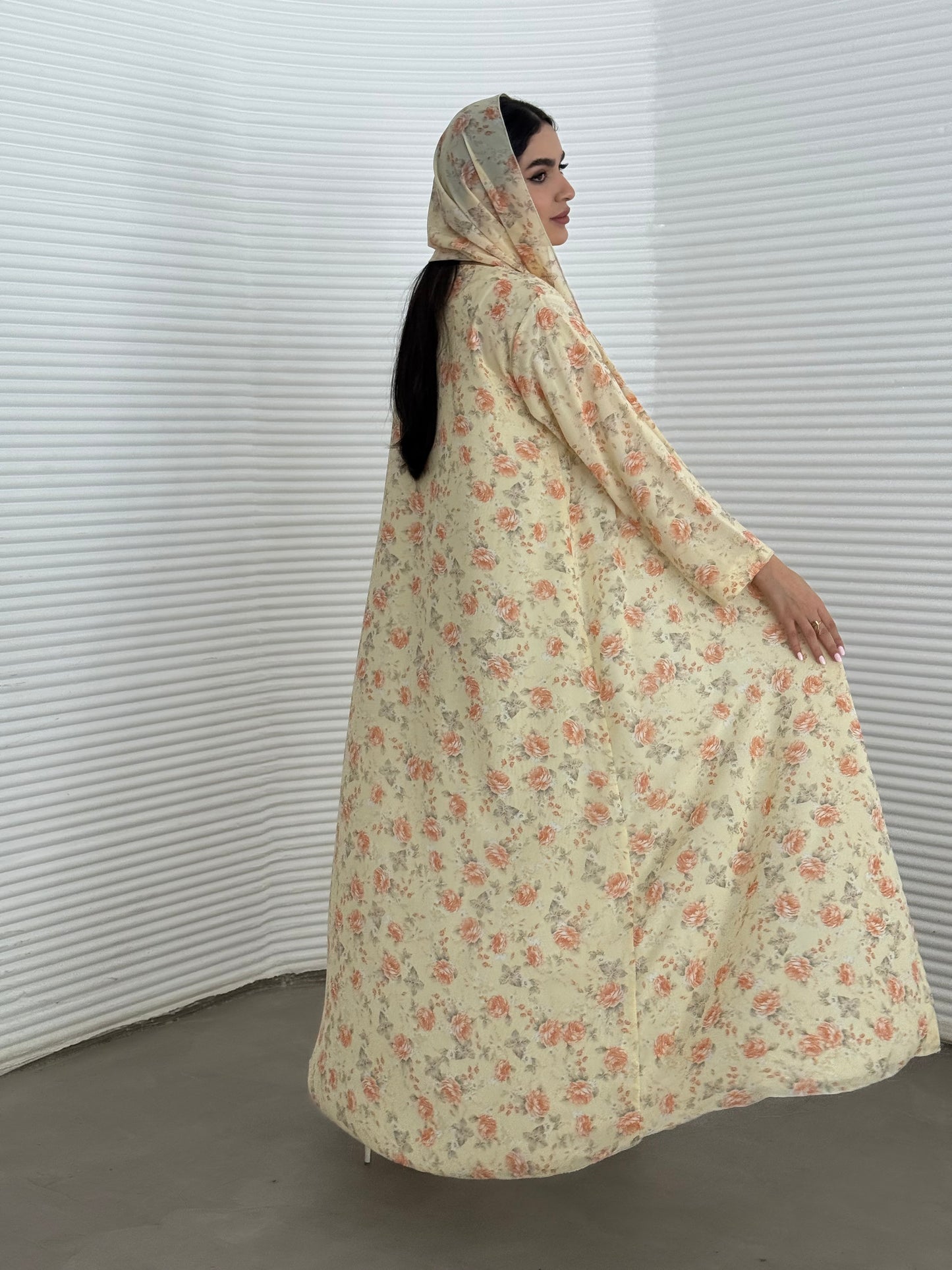 A soft yellow floral chiffon abaya, an elegant abaya that is perfect for summer, daytime events, artistic gatherings.