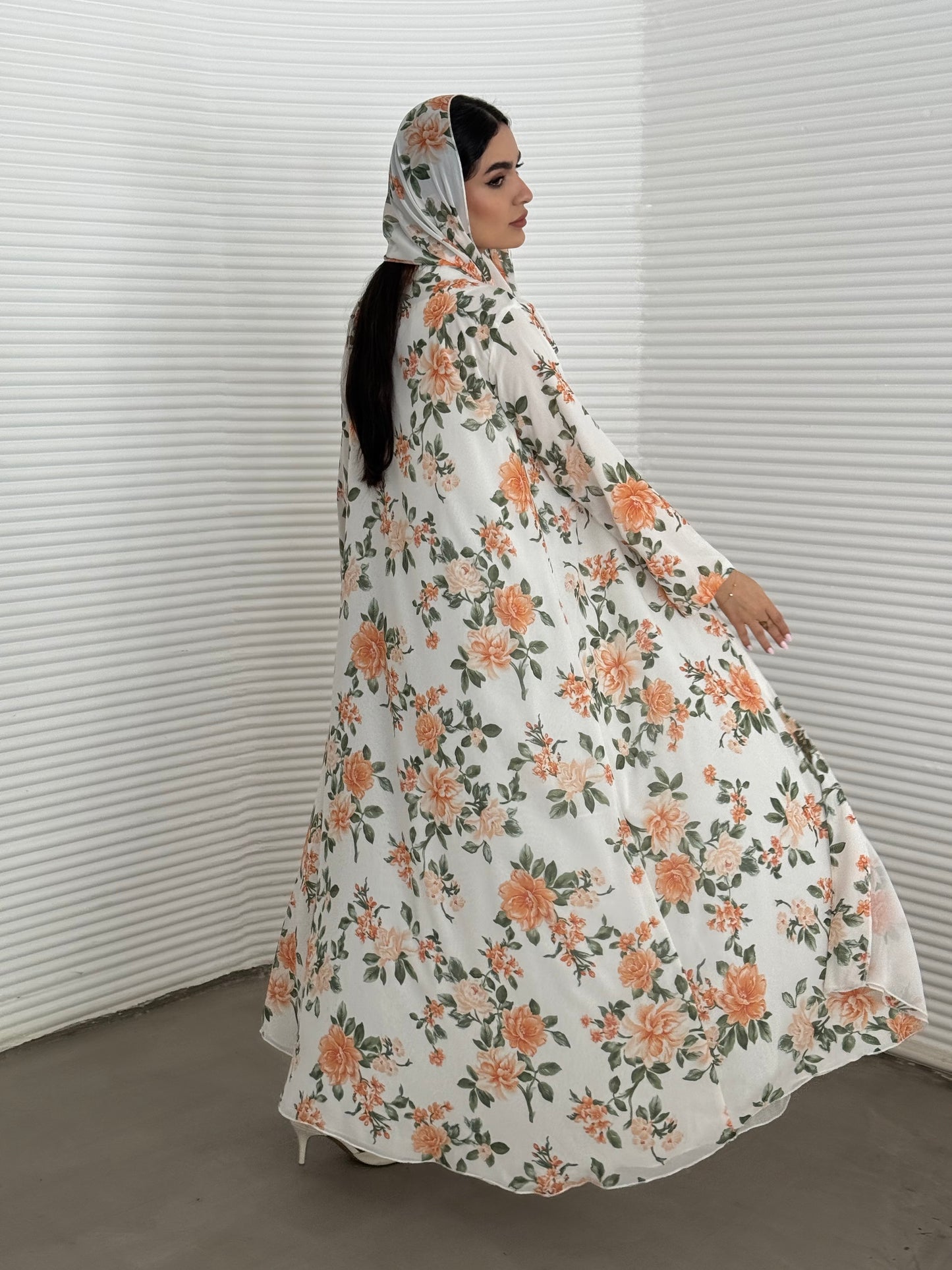 A white and orange floral chiffon abaya, an elegant abaya that is perfect for summer, daytime events, and brunch.