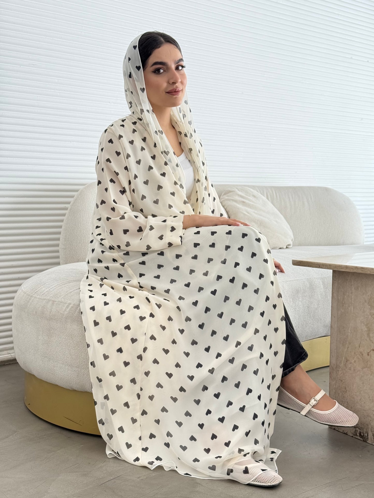 A cream heart print chiffon abaya, an elegant abaya that is perfect for summer, daytime events, and brunch.
