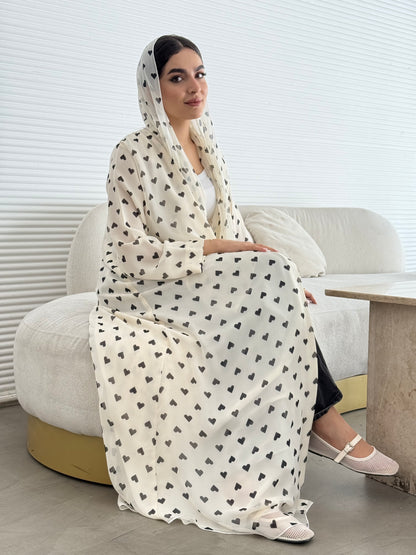 A cream heart print chiffon abaya, an elegant abaya that is perfect for summer, daytime events, and brunch.