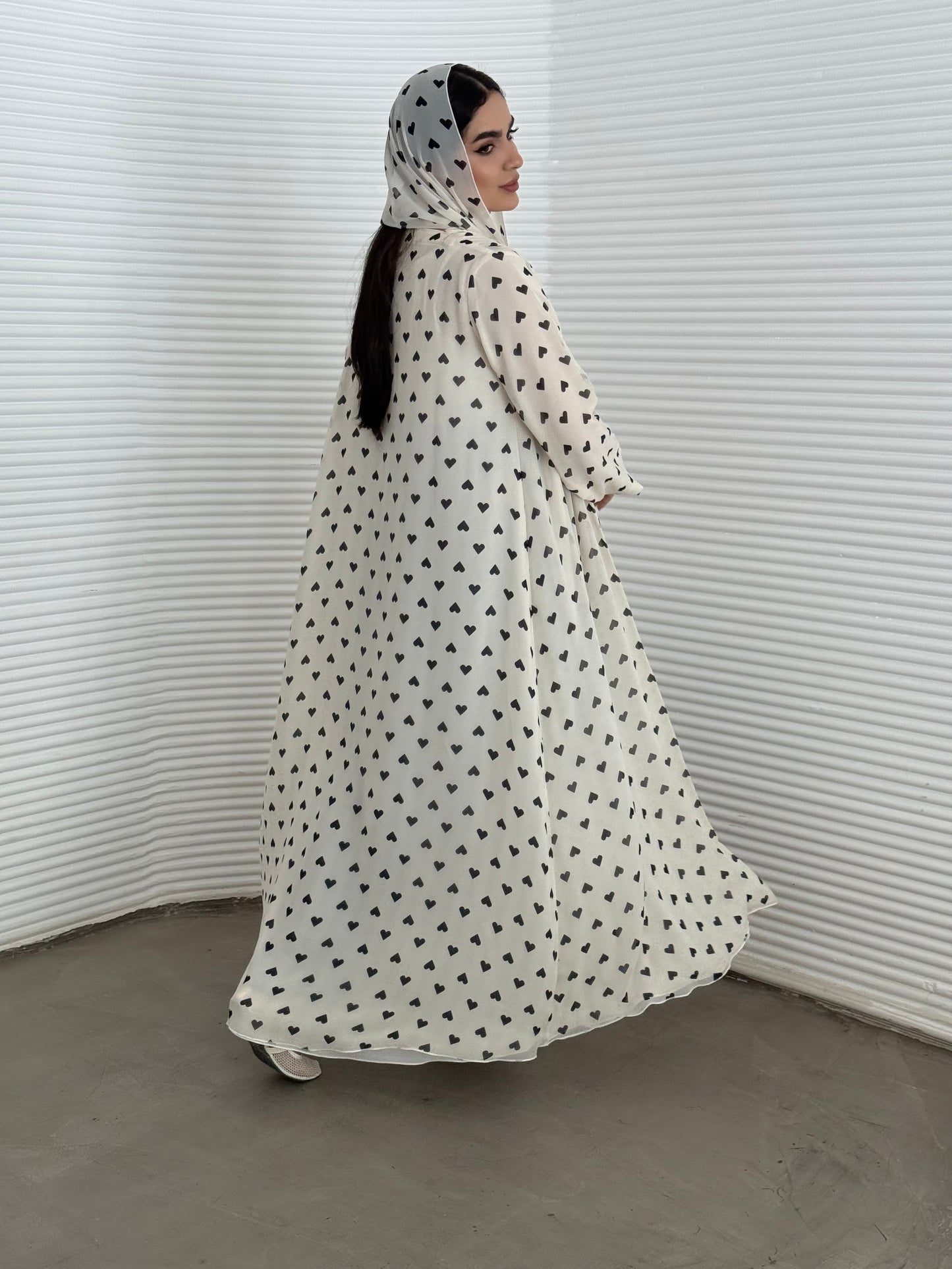 A cream heart print chiffon abaya, an elegant abaya that is perfect for summer, daytime events, and brunch.