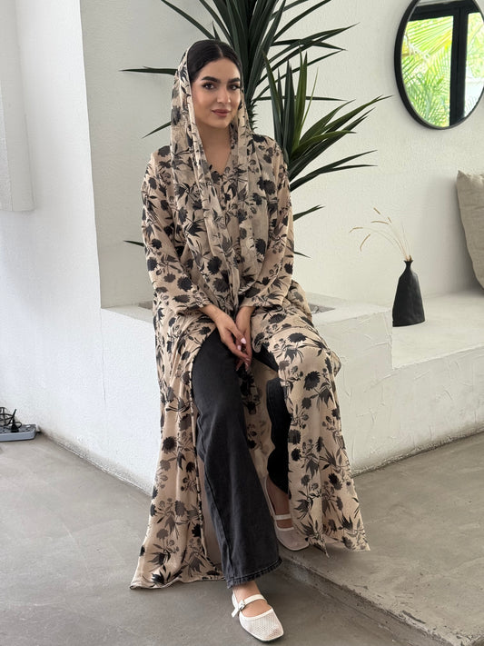 A beige and black floral chiffon abaya, an elegant abaya that is perfect for summer, daytime events, and brunch.