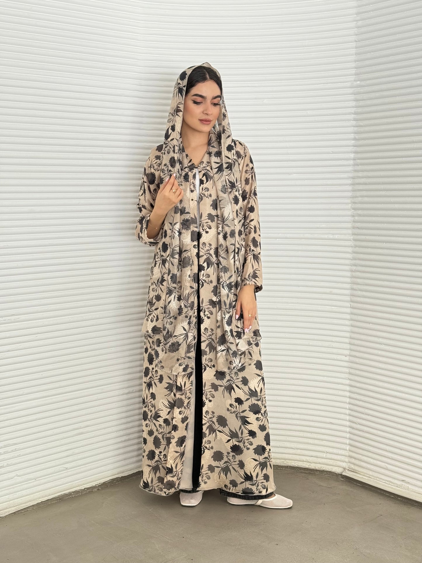 A beige and black floral chiffon abaya, an elegant abaya that is perfect for summer, daytime events, and brunch.