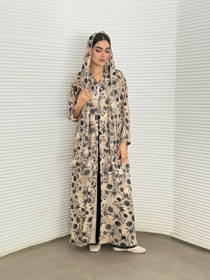 A beige and black floral chiffon abaya, an elegant abaya that is perfect for summer, daytime events, and brunch.