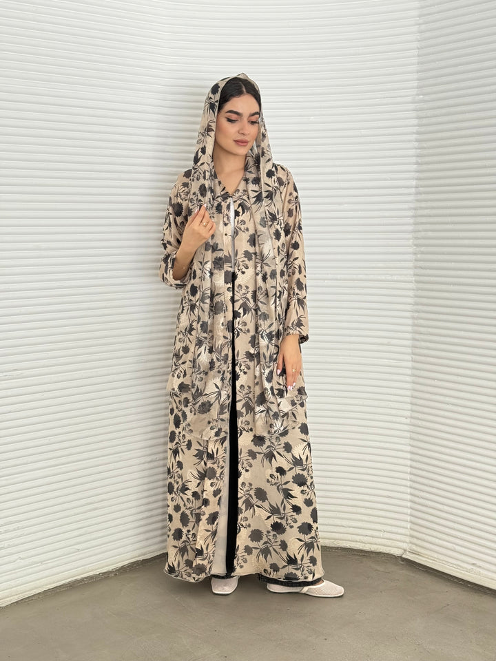 A beige and black floral chiffon abaya, an elegant abaya that is perfect for summer, daytime events, and brunch.
