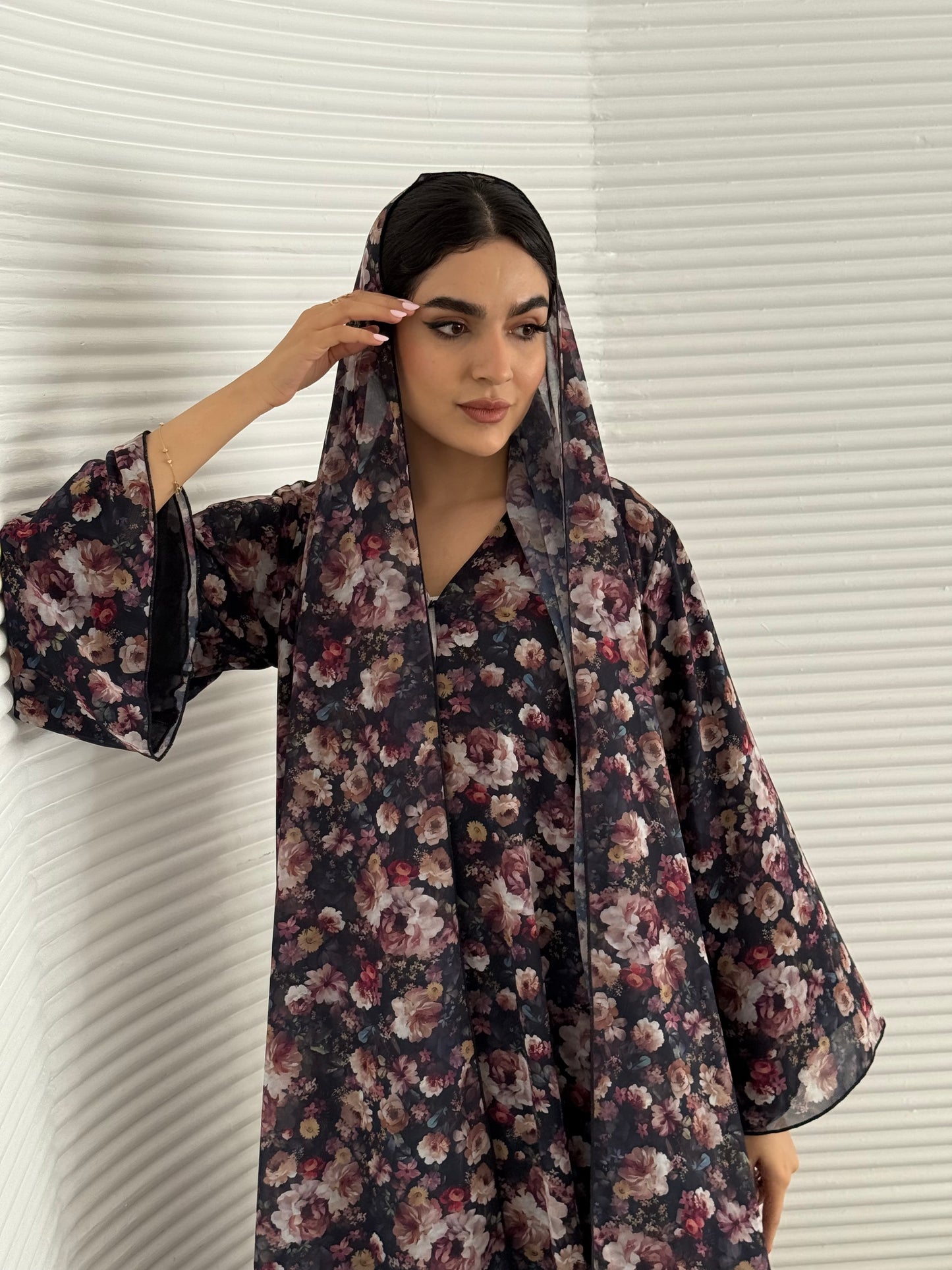 A deep dark blue floral chiffon abaya, an elegant abaya that is perfect for summer, daytime events, and brunch.