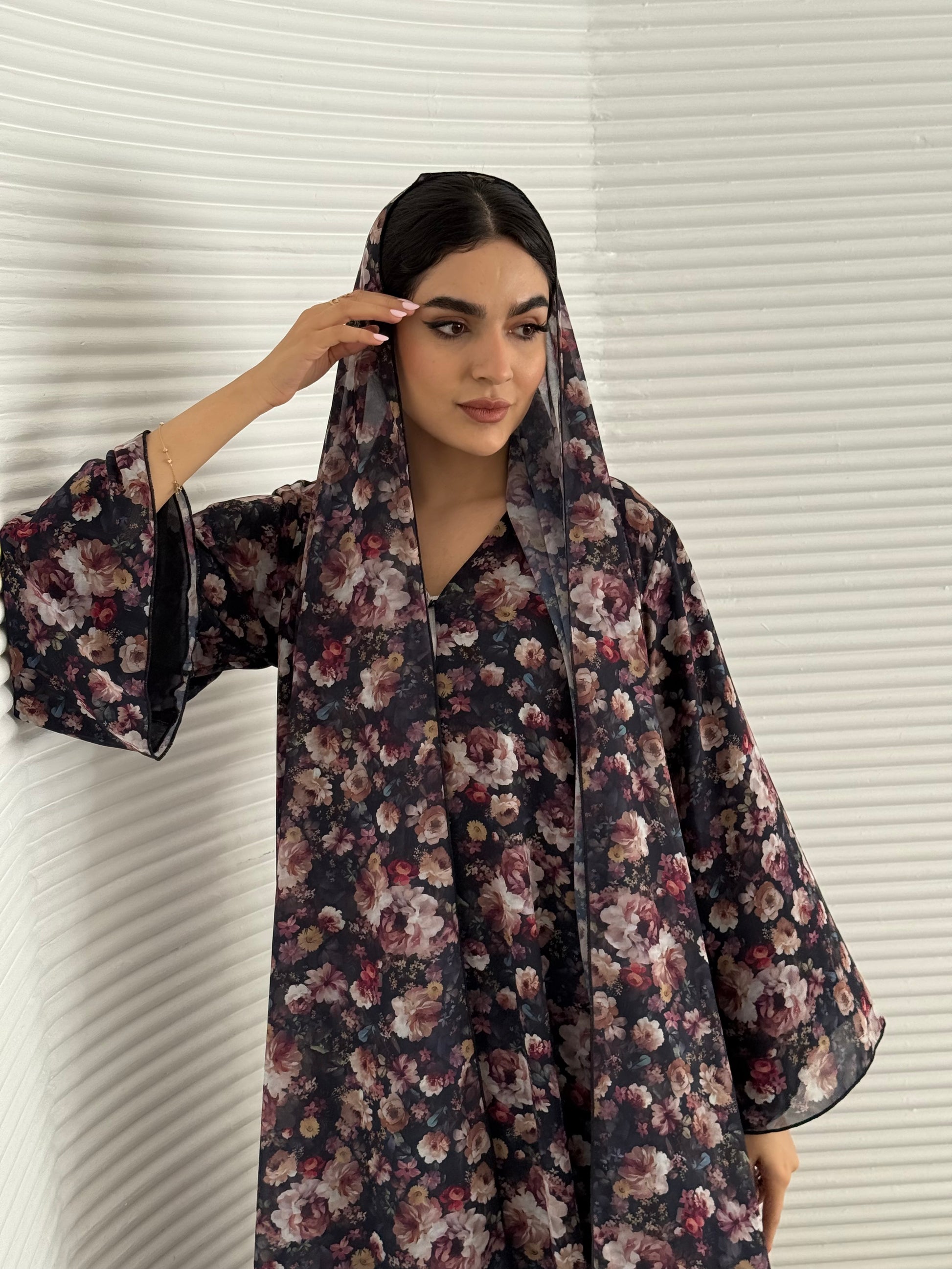 A deep dark blue floral chiffon abaya, an elegant abaya that is perfect for summer, daytime events, and brunch.