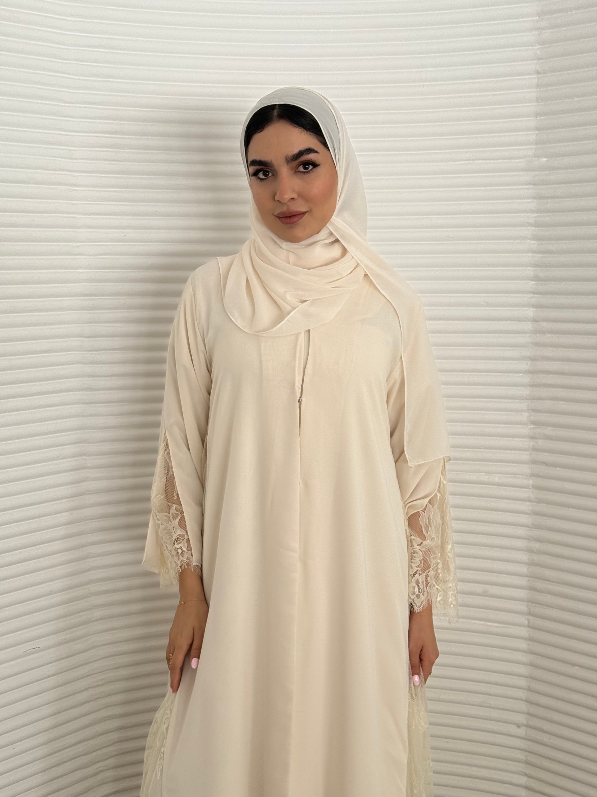 Classic cream abaya with smooth crepe and sheer lace. Making it an exquisite choice for Eid, Weddings and morning formal events.