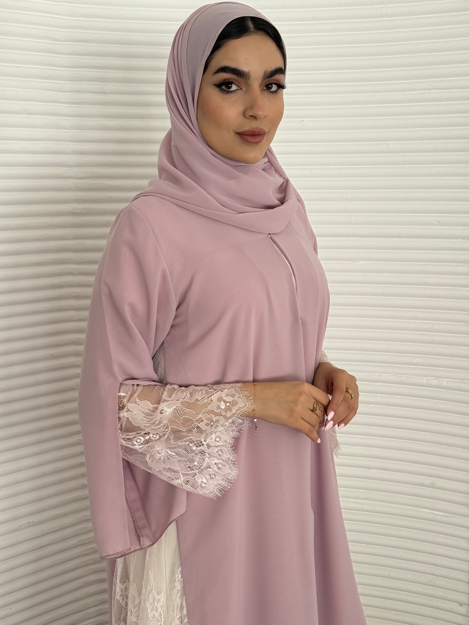 Classic lavender pink abaya with smooth crepe and sheer lace. Making it an exquisite choice for Eid, Weddings and morning formal events.