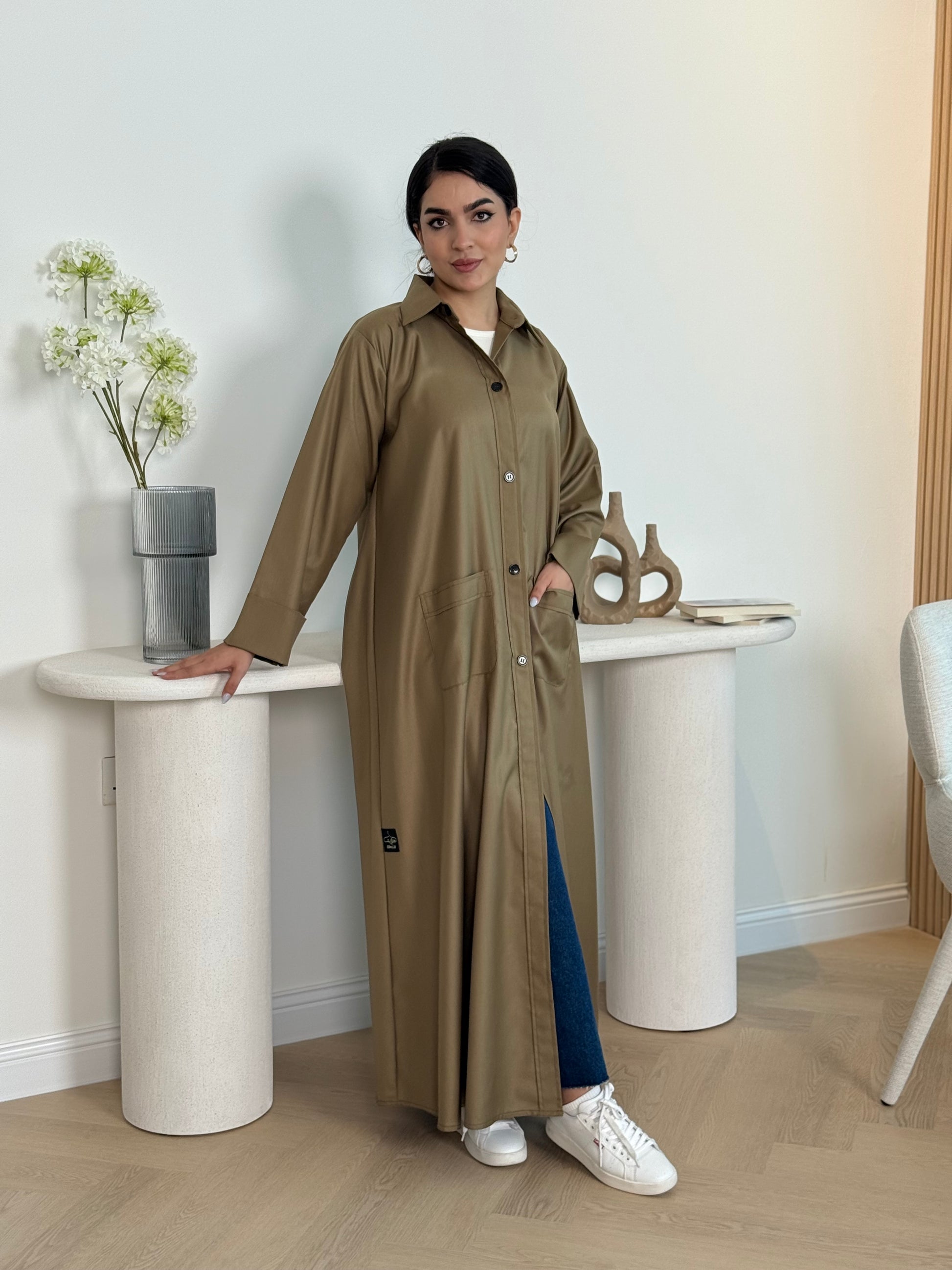 A dark cream linen abaya with smart collar and practical pockets, a perfect choice for office wear and everyday wear.
