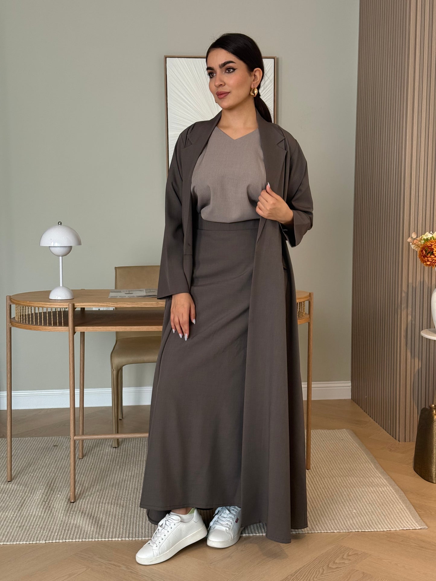 A coffee brown 3-piece abaya set that includes an open abaya, maxi skirt, inner top and sheila. This abaya is perfect for daytime  events, business settings/meetings or brunch.