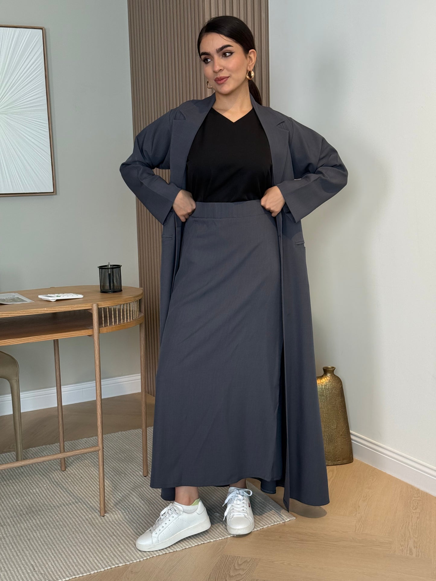 A dark grey 3-piece abaya set that includes an open abaya, maxi skirt, inner top and sheila. This abaya is perfect for daytime  events, business settings/meetings or brunch.