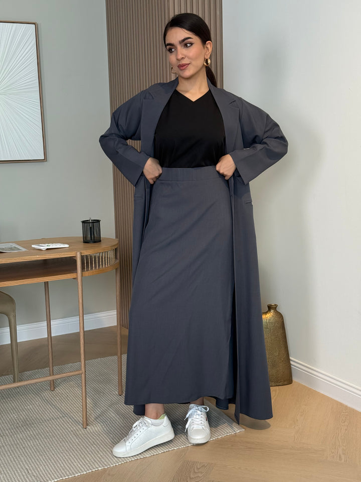 A dark grey 3-piece abaya set that includes an open abaya, maxi skirt, inner top and sheila. This abaya is perfect for daytime  events, business settings/meetings or brunch.