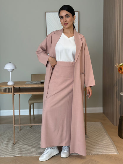 A dusty pink  3-piece abaya set that includes an open abaya, maxi skirt, inner top and sheila. This abaya is perfect for daytime  events, business settings/meetings or brunch.