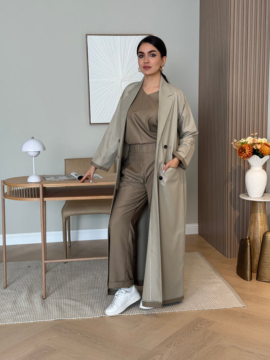 Woman in a Dark Beige Linen Abaya Set outfit standing in a room with a mirror reflecting her pose.
