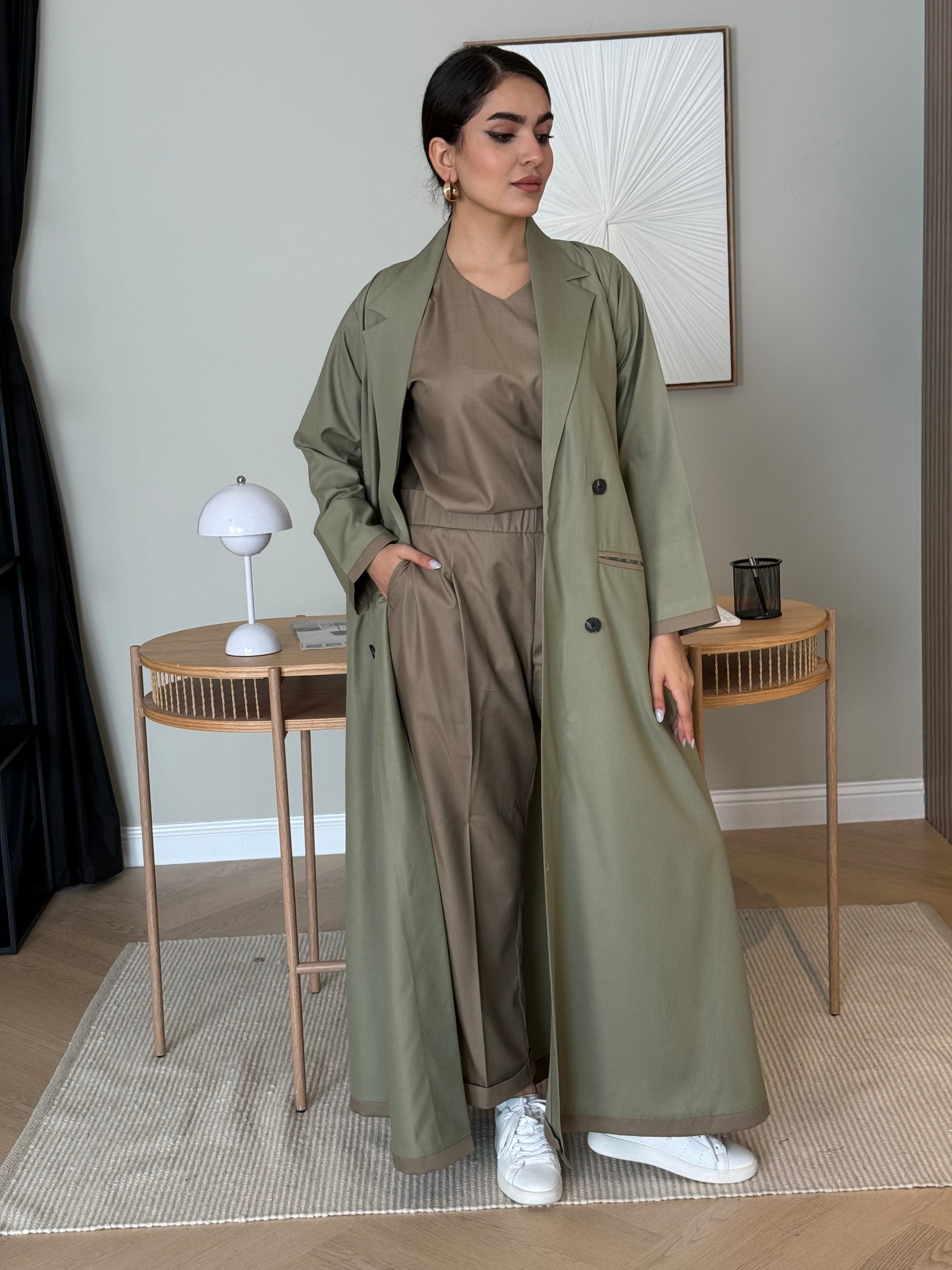 Person wearing a long Olive Green Linen Abaya Set standing in a room with a mirror reflection.