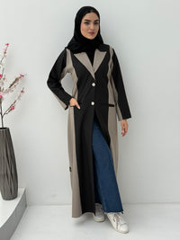Woman wearing a long, two-tone Black & Beige Linen Abaya with a matching sheila on a white background
