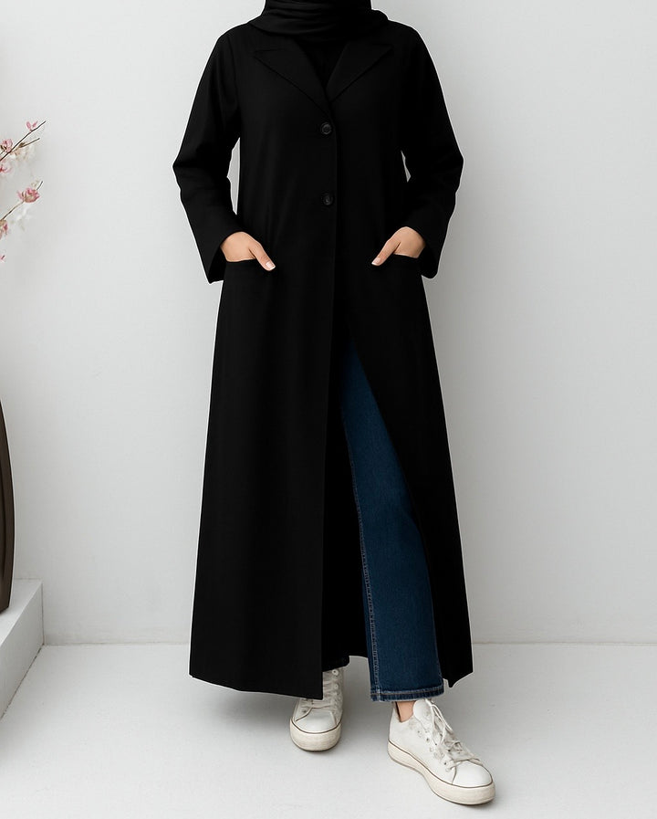 a woman wearing a Black Linen Abaya with a matching sheila on a white background 