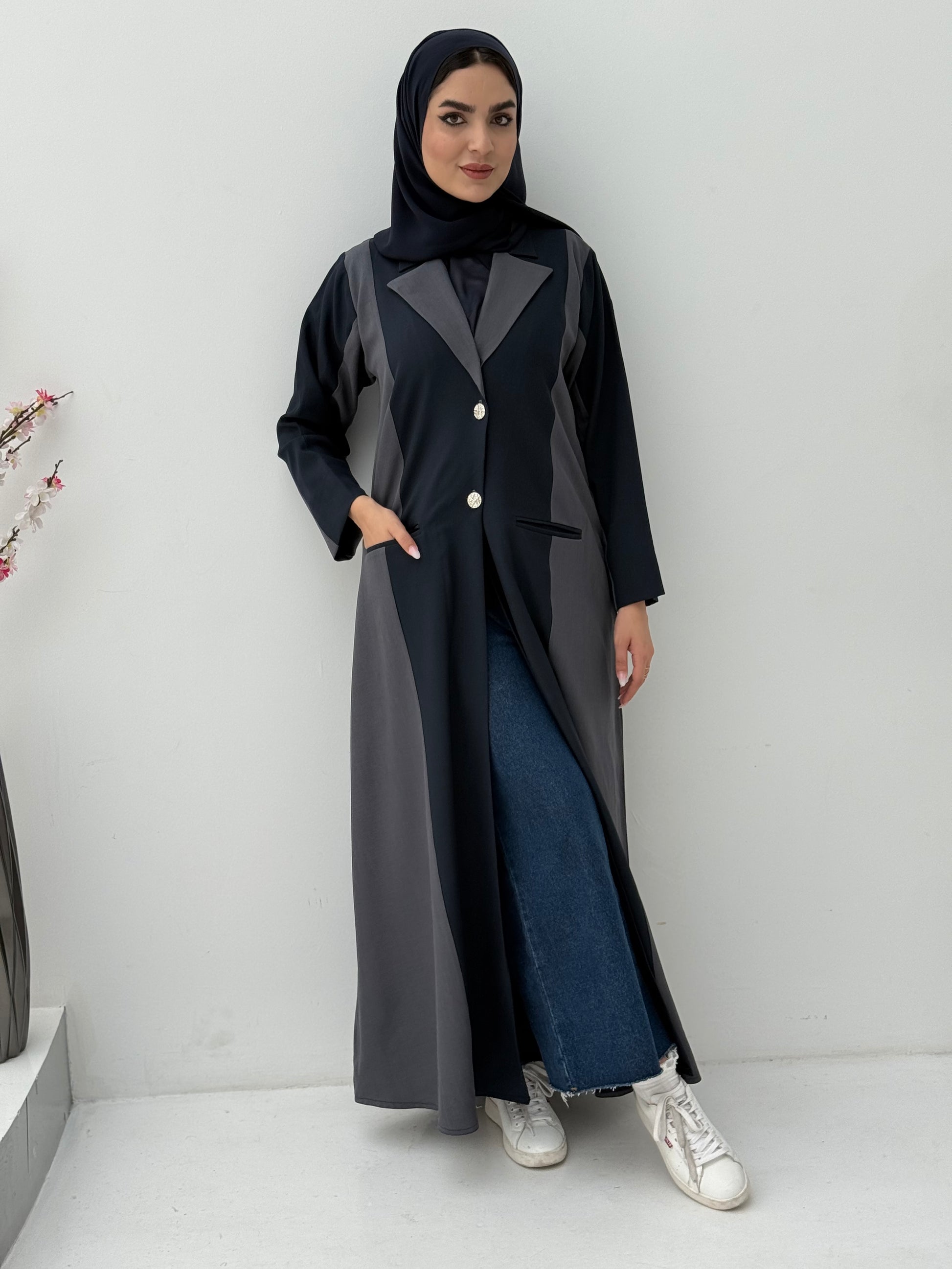 Woman wearing a long, two-tone Dark Navy Blue & Dark Grey Linen Abaya with a matching sheila on a white background