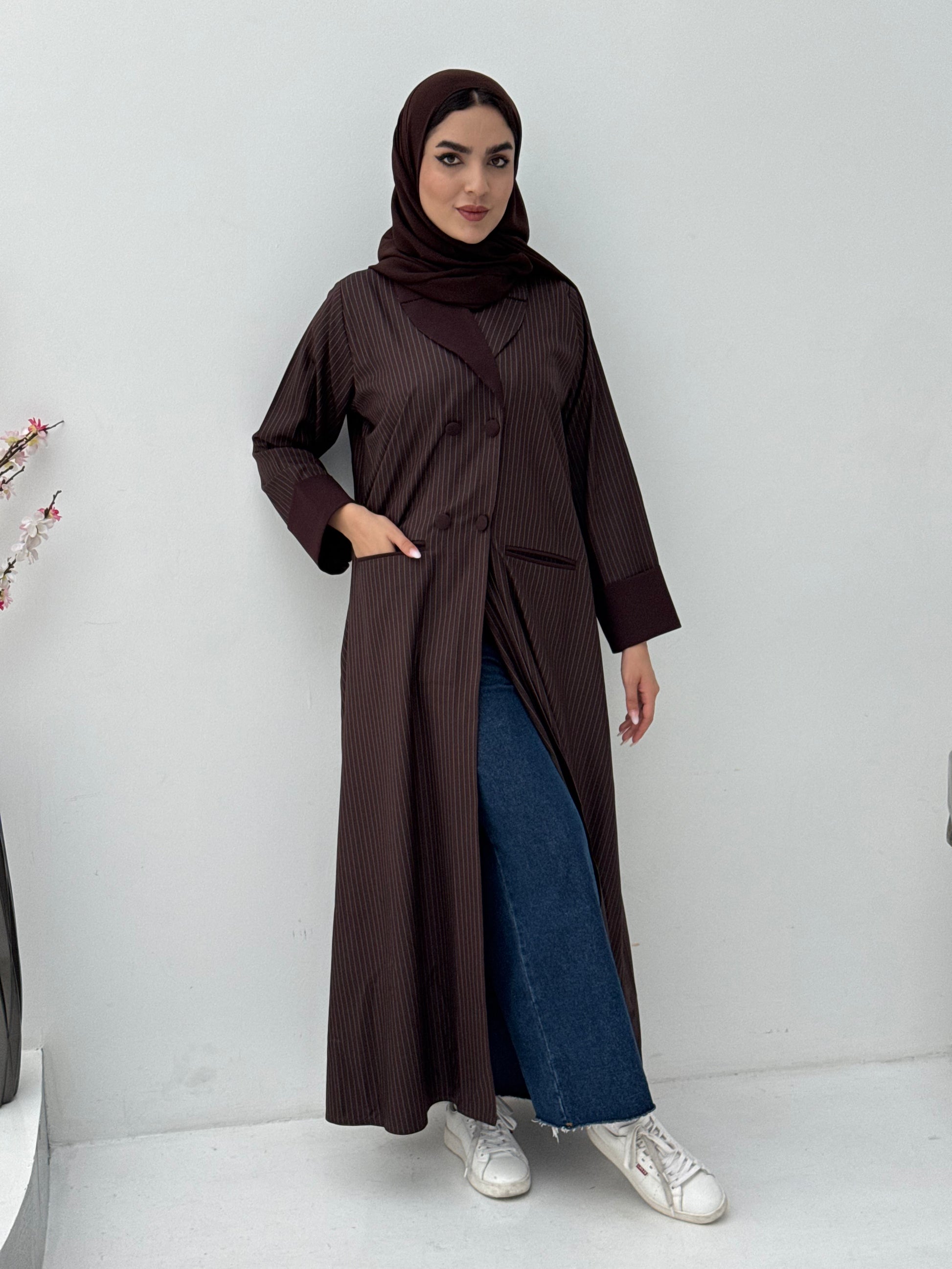 Woman wearing a Dark Brown Pinstripe Linen Coat Abaya on a white background