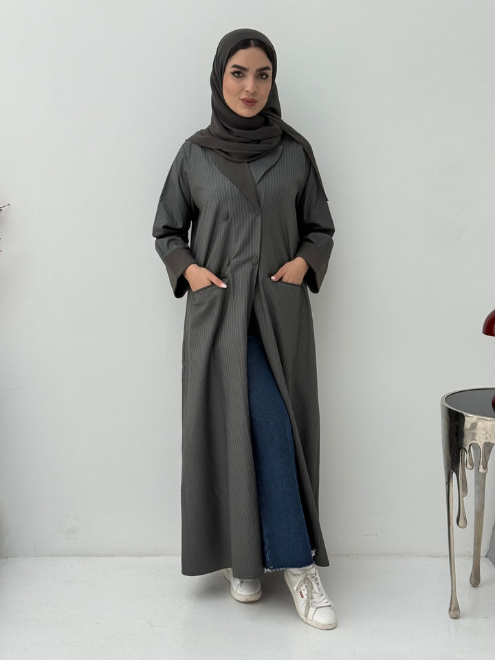 Woman wearing a long Dark Olive Pinstripe Linen Coat Abaya with a hood against a white background