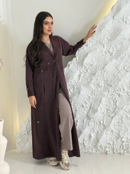 Woman wearing a Dark Maroon Shamwa Trench Abaya Set over a gray outfit against a neutral background