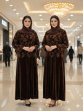 Two identical women in Dark Brown Velvet Embroidered Abayas with floral patterns standing in a mall.
