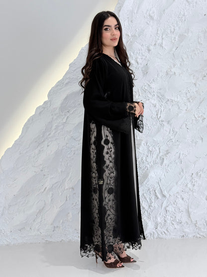 Person wearing a Premium Black Hand-Embellished Abaya made from Nida fabric and Sheer Mesh Panel outfit on a white background