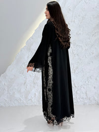 Person wearing a Premium Black Hand-Embellished Abaya made from Nida fabric and Sheer Mesh Panel outfit on a white background